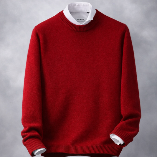 Red sweater with white trim on a wooden surface and gray background